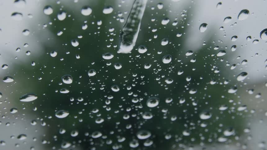 Drops of rain over a glass window during day time