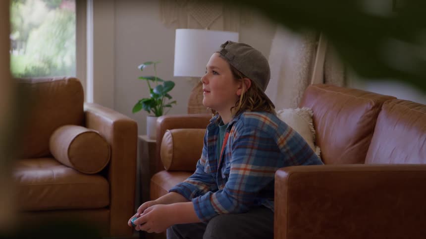 A person playing video games on a couch