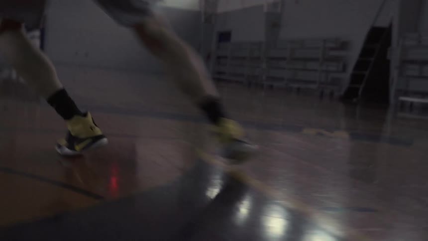 A man practices drills on a basketball court