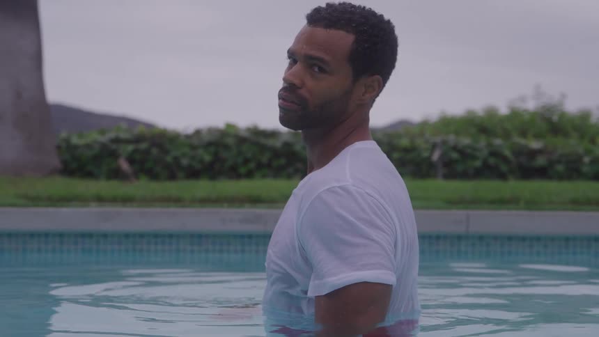 Man in a pool looks forward with water at chest level