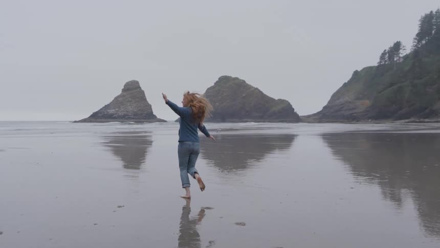 The woman runs on the foggy beach
