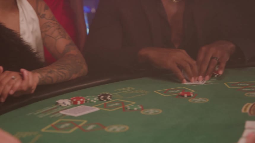 Players moving chips on a casino table