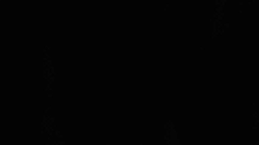 Two boxers are boxing against a black background and flashing lights