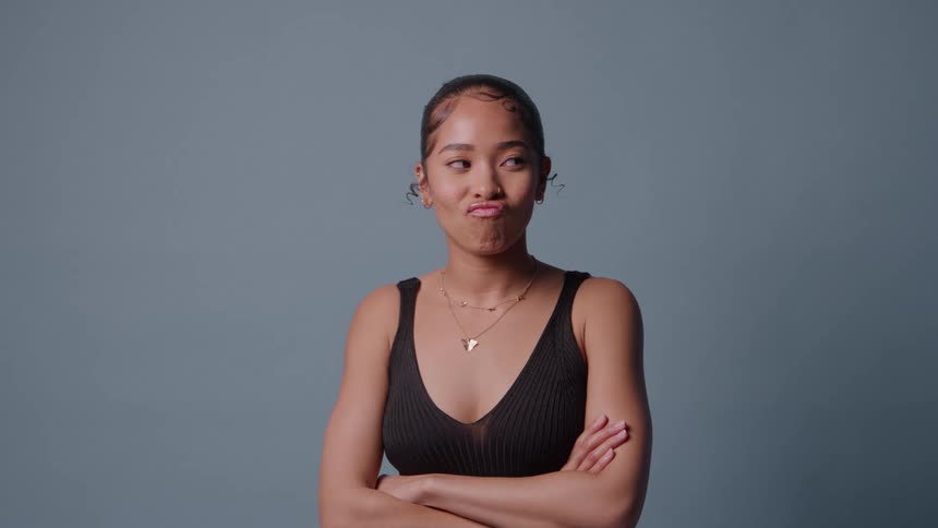 Young black woman making funny faces at a studio indoors