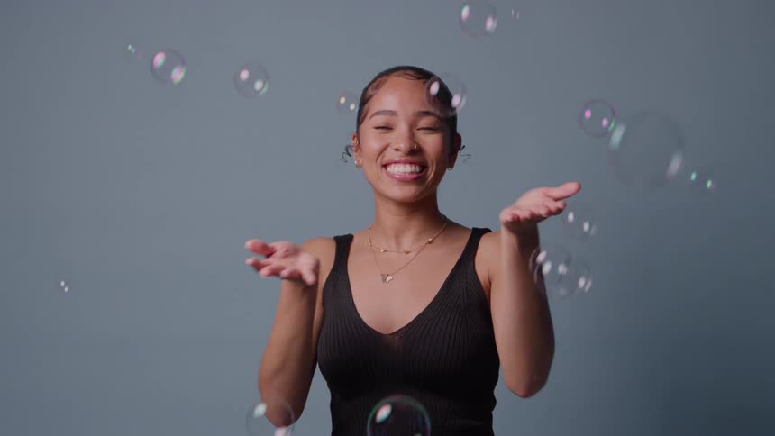 Woman in a studio with soap bubbles around her