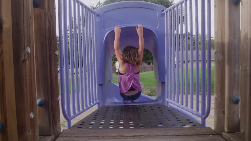 A child playing on a jungle gym