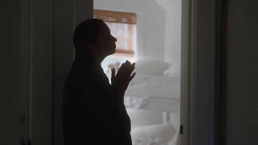 Silhouette of woman standing in doorway