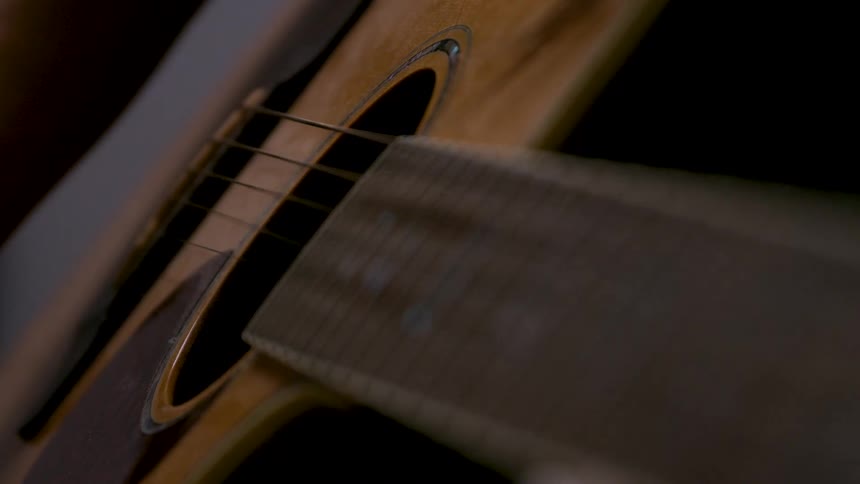 The man strums the guitar