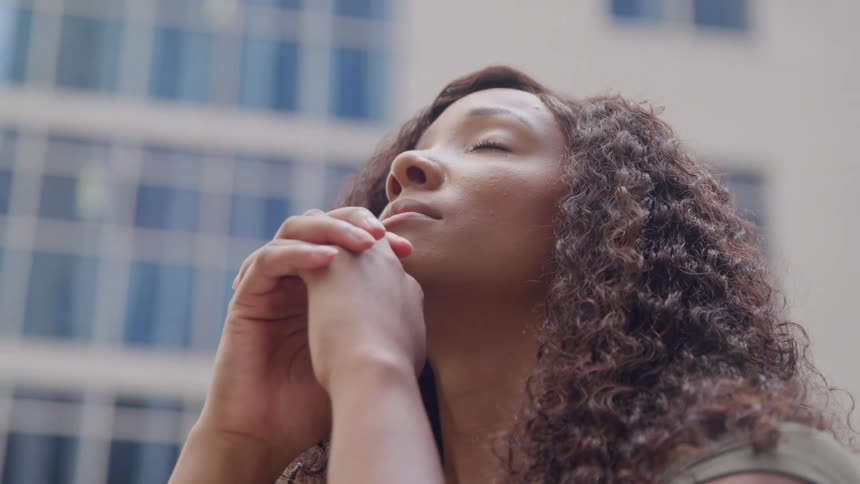 The woman is praying outside
