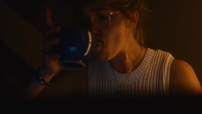 A woman drinking tea from a mug