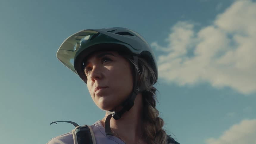 A woman outdoors wearing a helmet