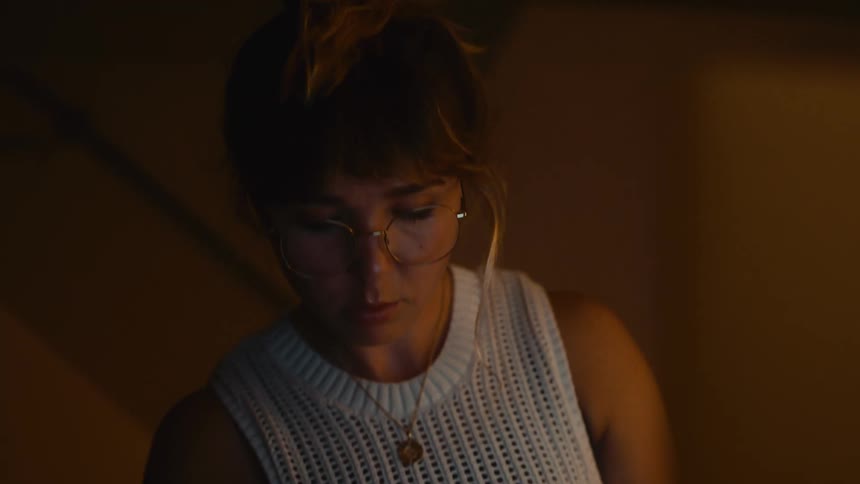 A woman writing in a room
