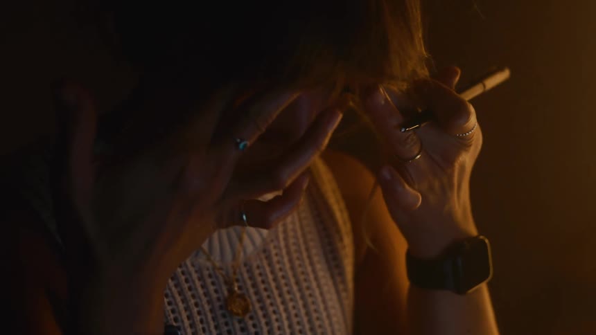 A woman taking off her glasses and rubbing her eyes