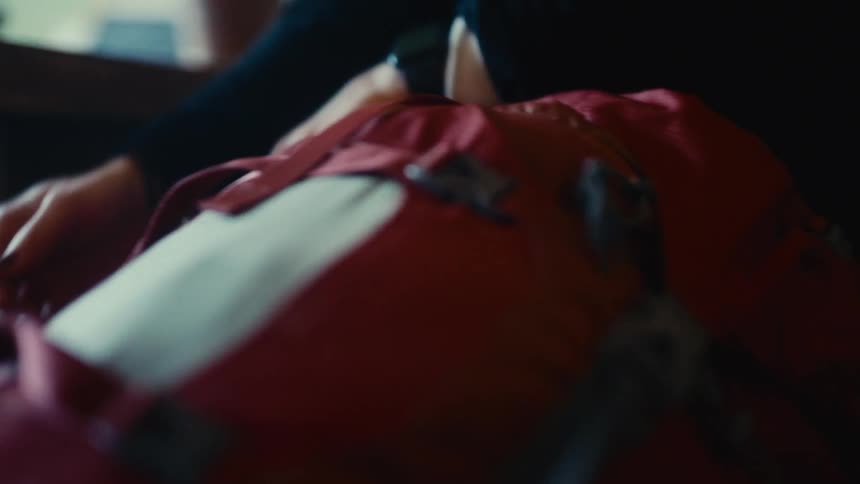 A person buckles a bag