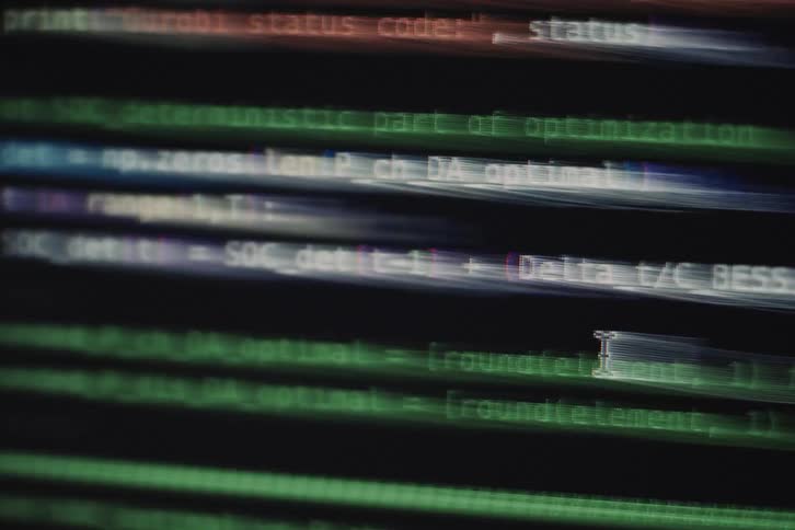 A black screen with various codes in different colors flashing by rapidly