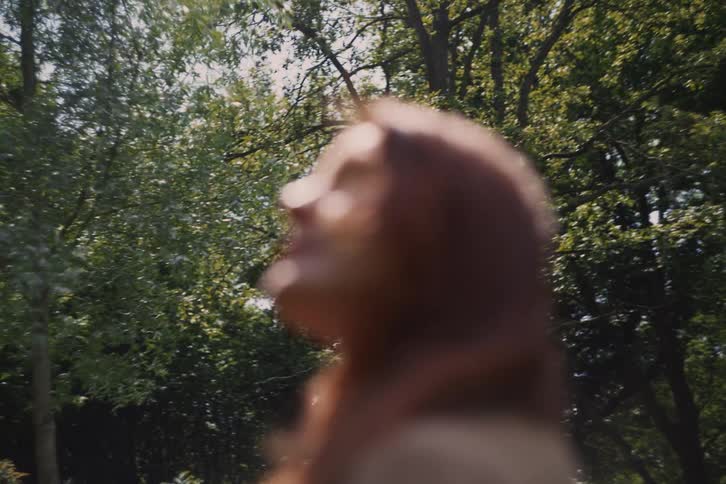 The wind is blowing the hair of the hiking woman