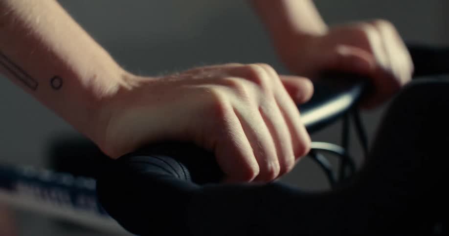 Hands gripping a bicycle handlebar
