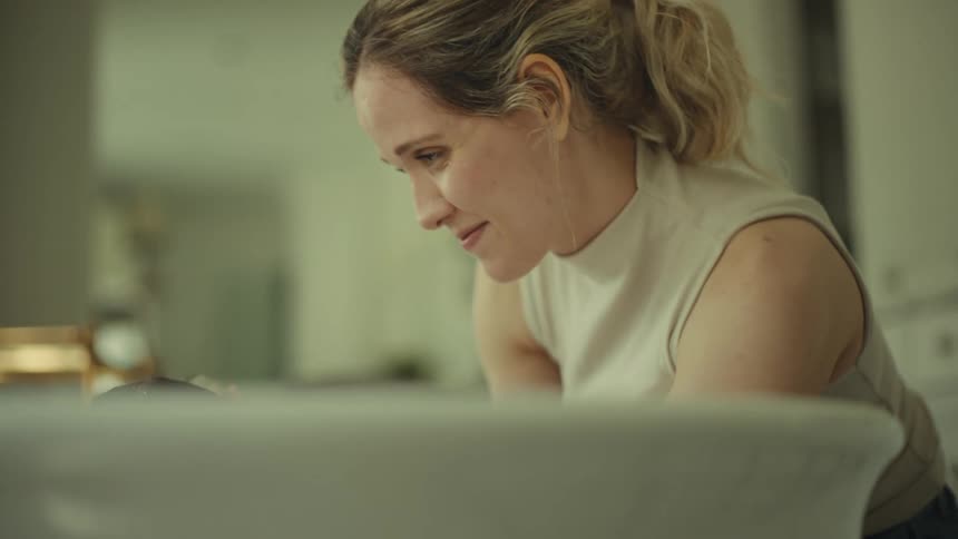 Close up of a young woman washing in a tub in the bathroom during daytime