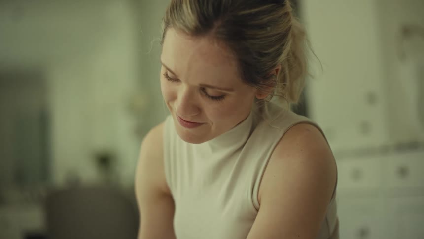 Woman leaning forward in an indoor setting