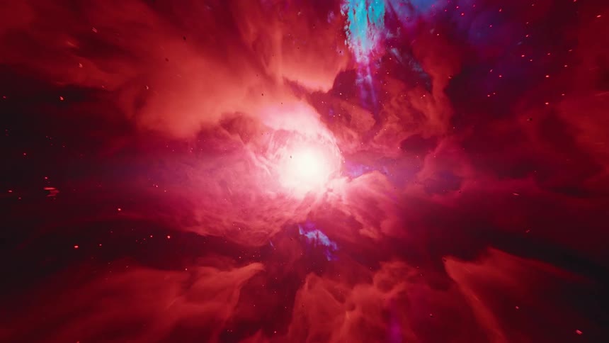Light glows from the center of a multicolored gaseous mass as small hard objects float through it