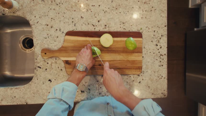 The man is cutting up an apple