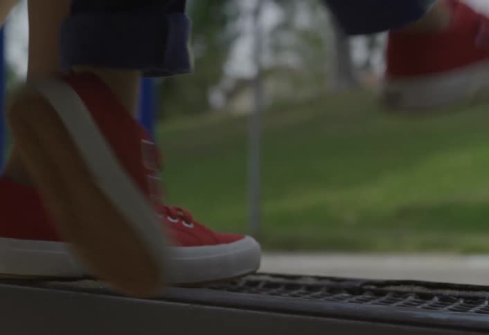 Red sneakers swinging in motion