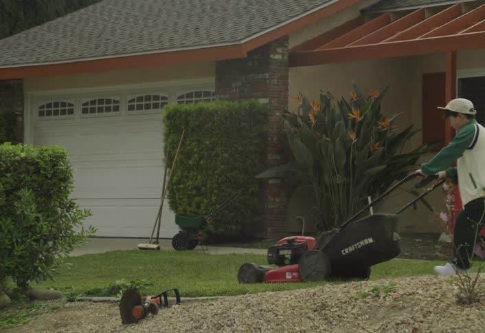 The bow is moving the lawn in front of the home