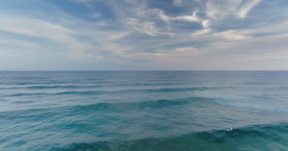 Ocean surface with small waves under a partly cloudy sky