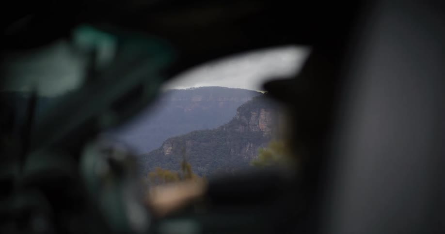 Mountain landscape seen through a blurred vehicle window