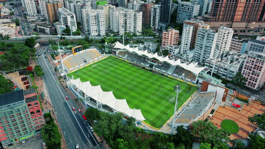 An aerial view of a soccer field in a large city