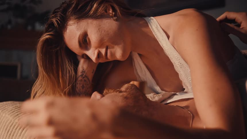 A man and woman cuddling in a room