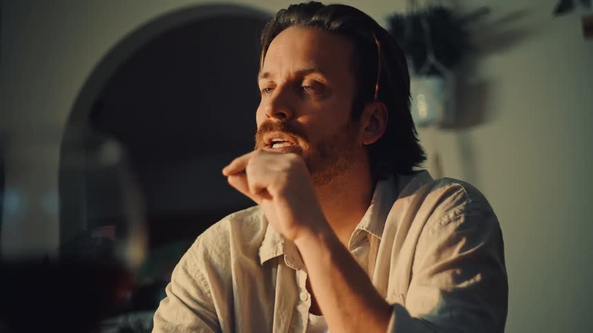 A man sitting and having a conversation with someone