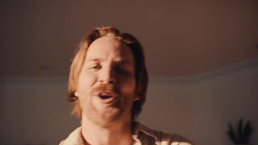 The man is dancing and singing