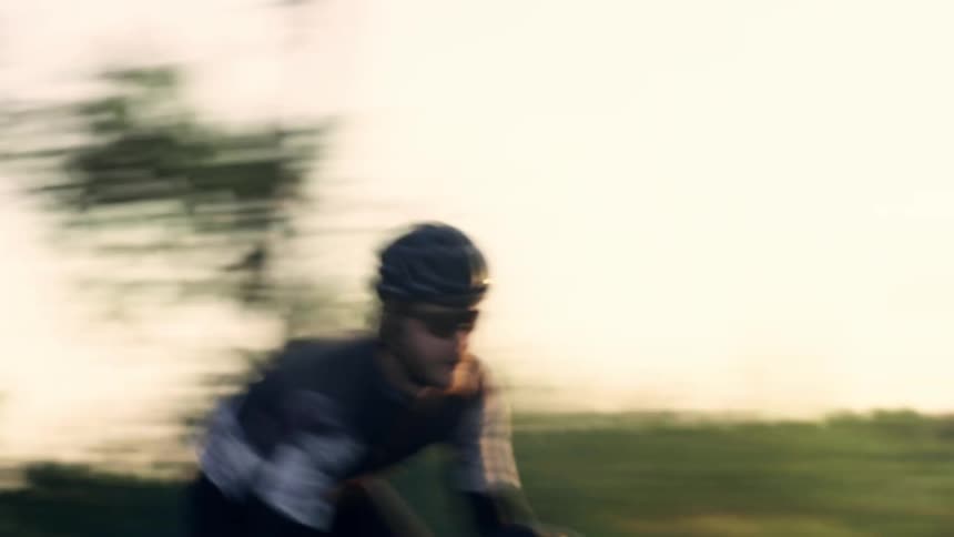 The man is racing his bicycle