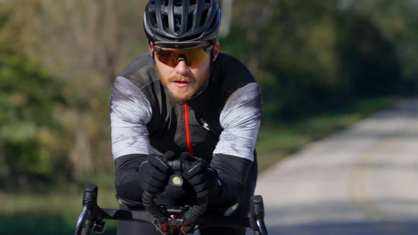 A man riding a bicycle down a road