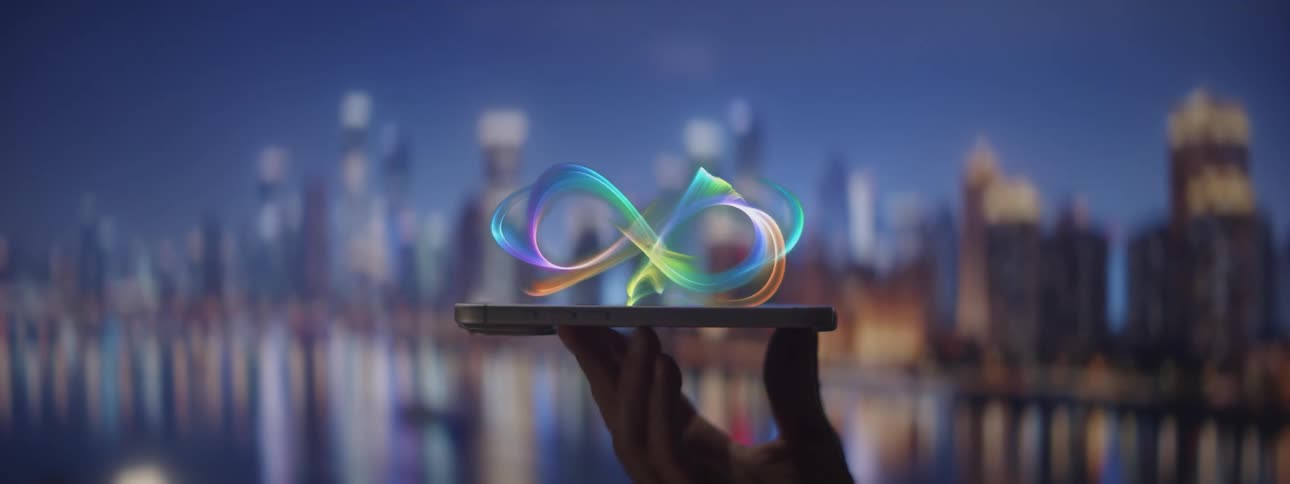 Glowing infinity symbol floats above a smartphone held by a hand with a blurred city in the background