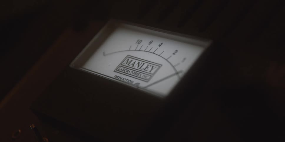Analog meter displays reduction scale with needle pointing toward lower values