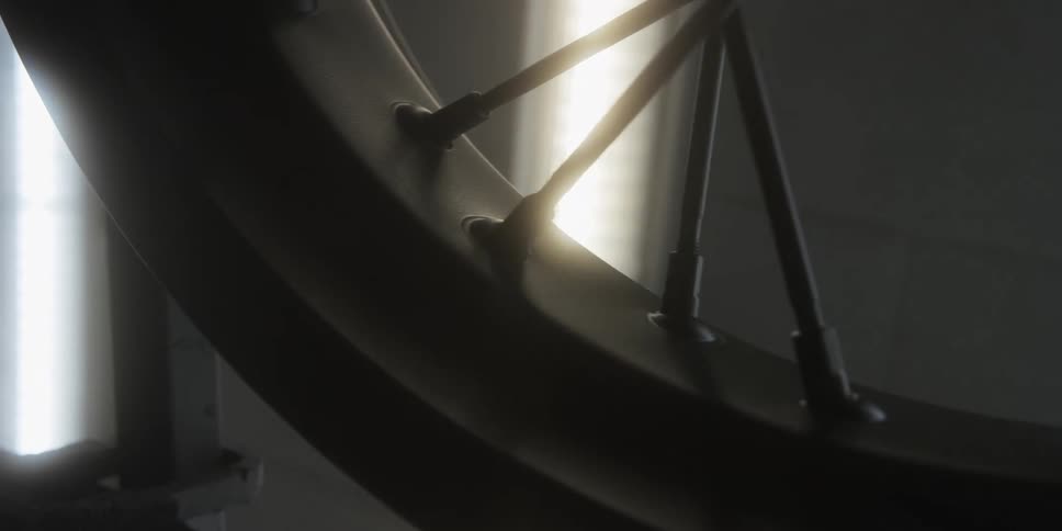 Closeup of a metal motorcycle wheel rim that has welded spokes on it