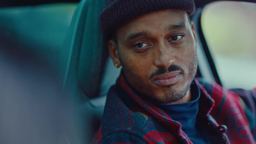 Man sitting in a car looking to the side