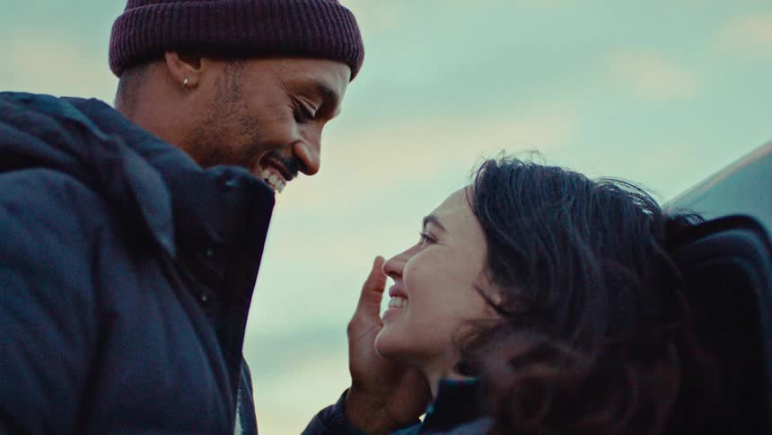 Couple smiling closely while looking at each other outdoors