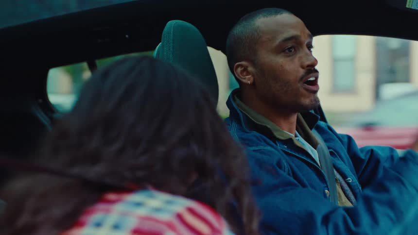 Couple inside a car moving their arms in a dancing motion while driving