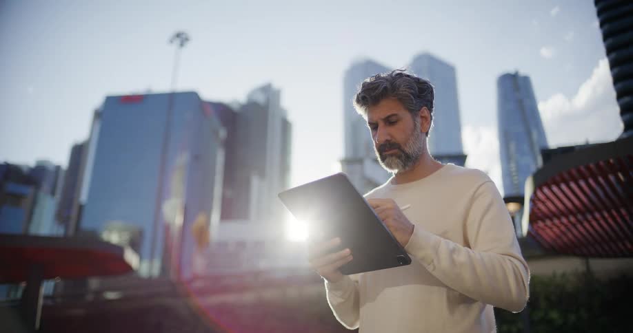 A man using a tablet outdoors