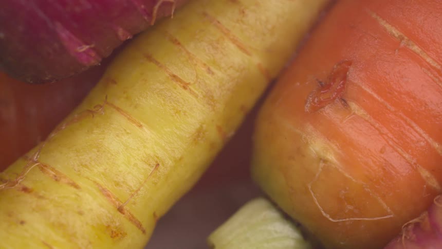 Close up view of carrots and produce on a table