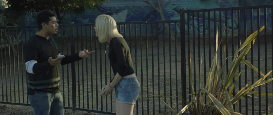 A man and woman argue in an urban setting