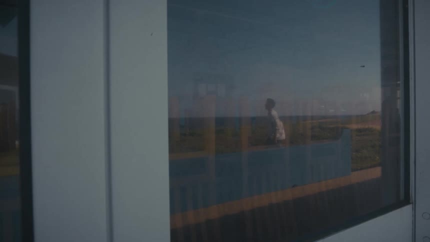 Reflection of a man walking captured in a glass window