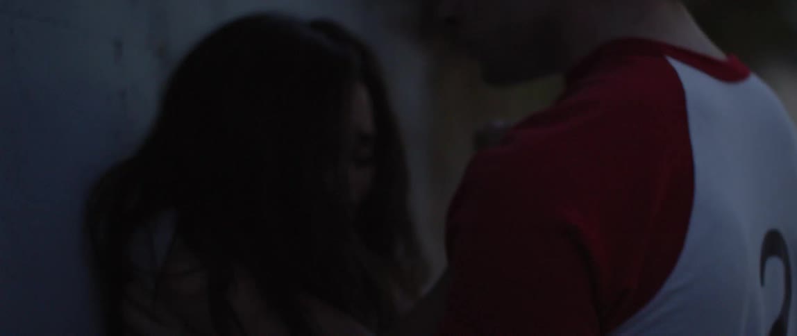 A man is holding onto a woman who is struggling against him