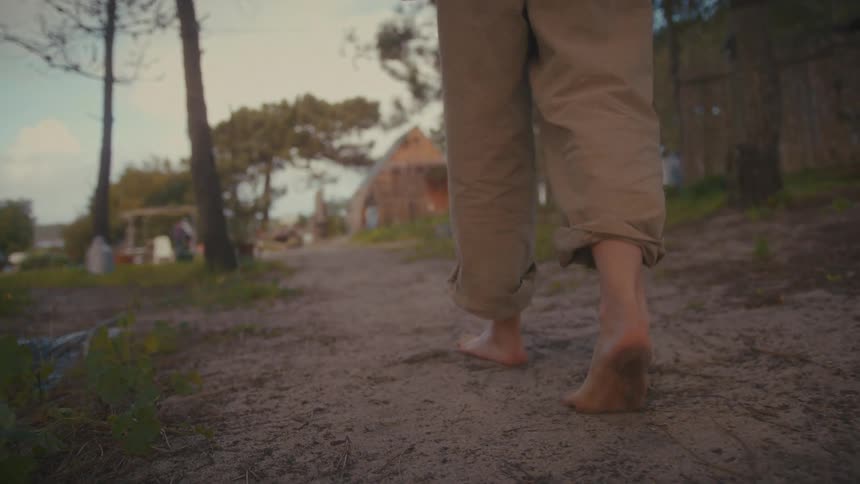 A person walking outdoors in a rural area