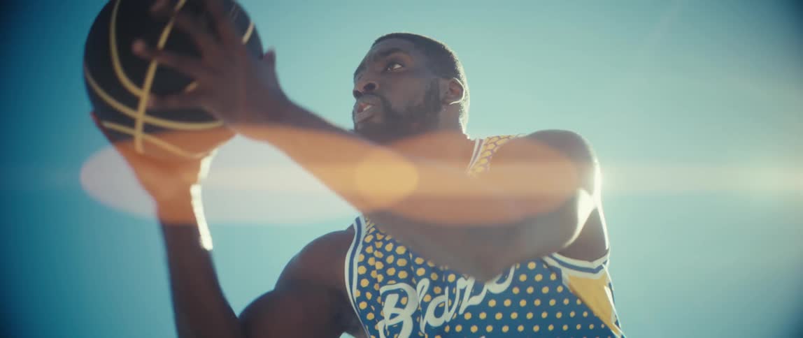 Man picking up a basketball
