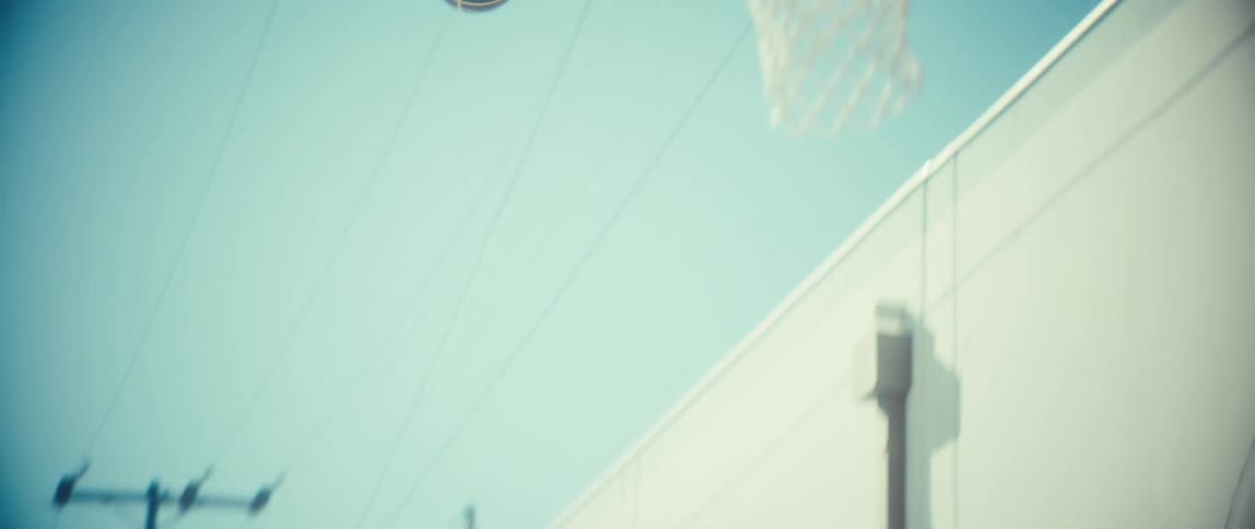 A man shooting a basketball outdoors