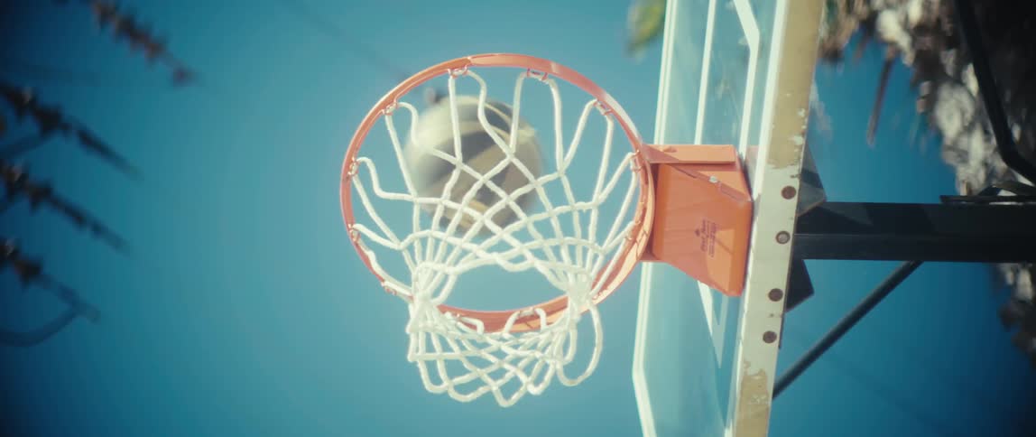Basketball passes through outdoor hoop
